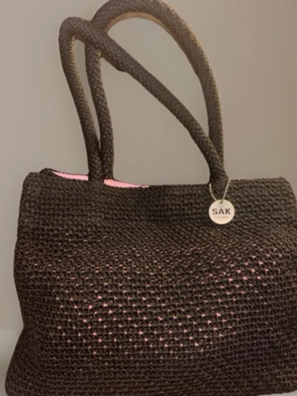 The Sak Black Crochet Tote with Pink Interior Accent